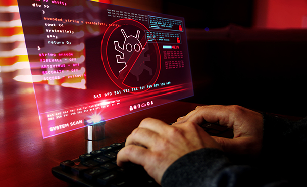 Malicious hacker in front of a screen